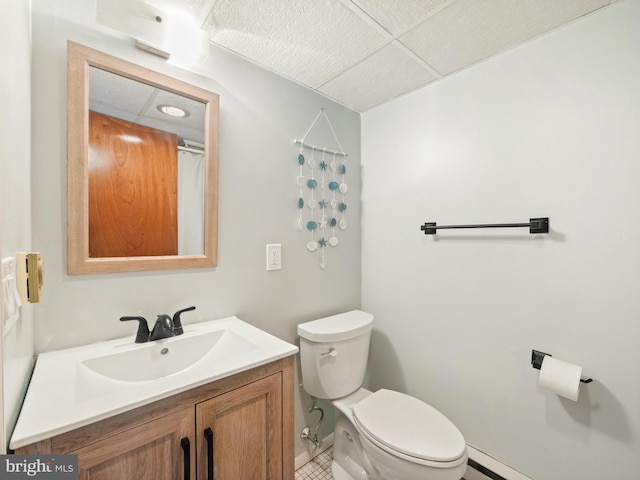 bathroom with a baseboard heating unit, vanity, and toilet