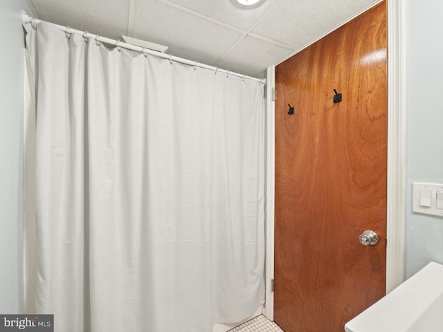 bathroom with a drop ceiling