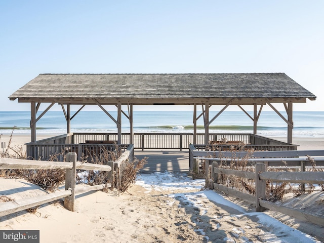 view of home's community featuring a beach view and a water view