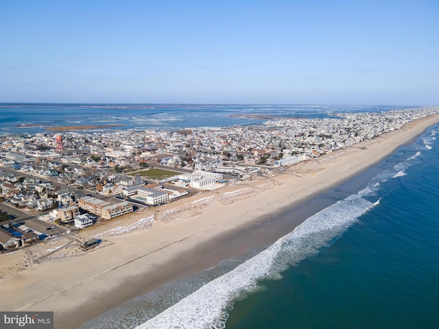 birds eye view of property featuring a water view and a view of the beach