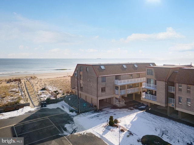 birds eye view of property featuring a beach view and a water view