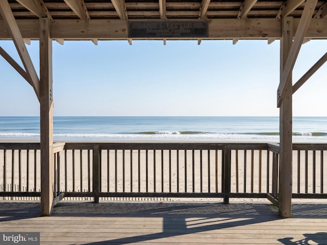 deck featuring a water view and a view of the beach