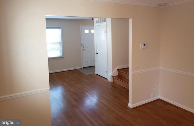 entryway featuring hardwood / wood-style flooring and ornamental molding