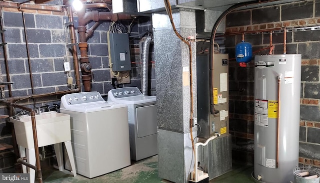 utility room featuring washing machine and dryer, water heater, and electric panel