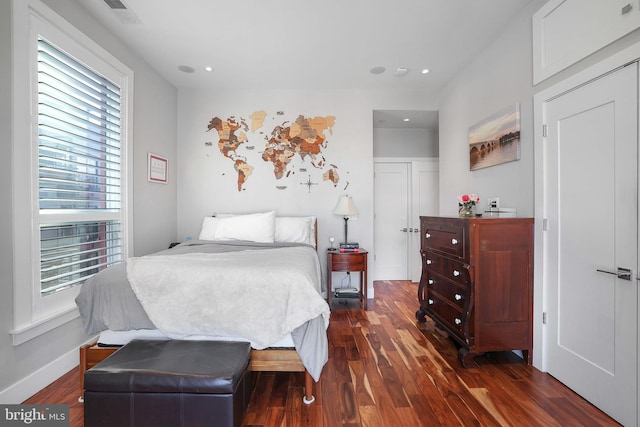 bedroom with dark hardwood / wood-style flooring