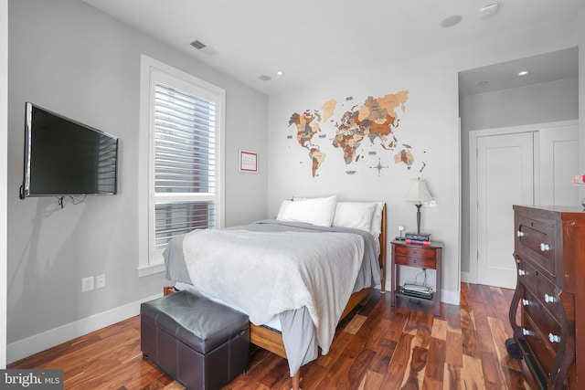 bedroom with dark hardwood / wood-style flooring