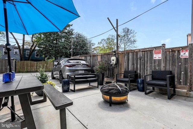 view of patio / terrace featuring an outdoor fire pit