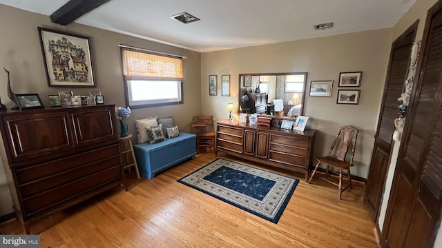 interior space featuring light hardwood / wood-style floors and beamed ceiling