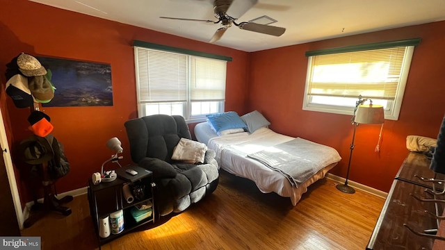 bedroom with wood-type flooring and ceiling fan