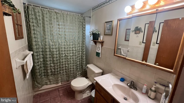 full bathroom with tile walls, tile patterned floors, toilet, and shower / bath combo with shower curtain