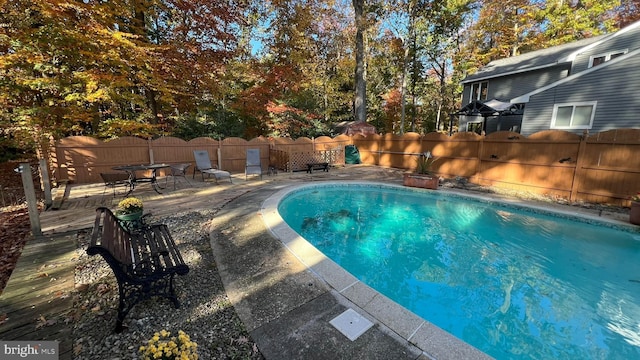 view of swimming pool with a wooden deck