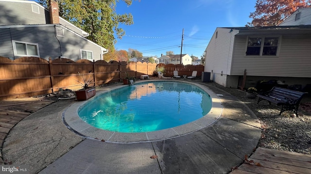 view of pool with central air condition unit