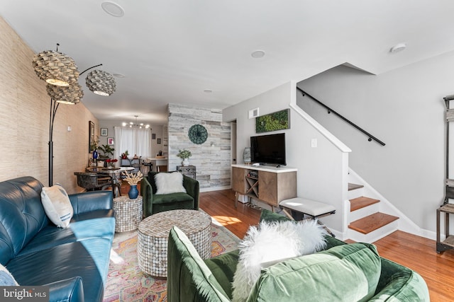 living room featuring wood-type flooring and brick wall