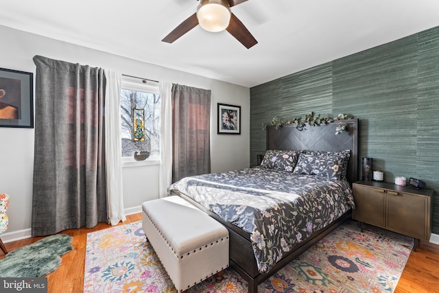 bedroom with ceiling fan and light hardwood / wood-style floors