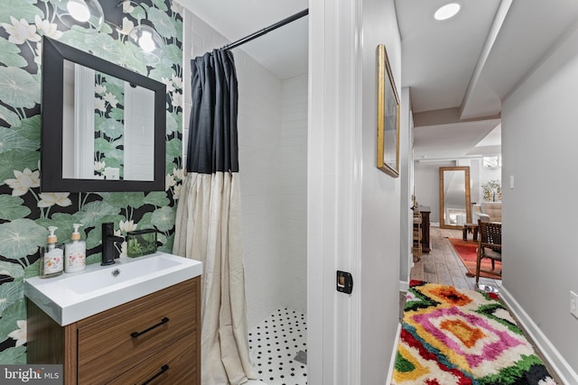 bathroom with vanity, hardwood / wood-style flooring, and walk in shower