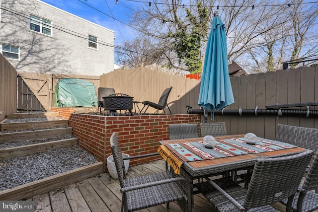 wooden deck with an outdoor fire pit