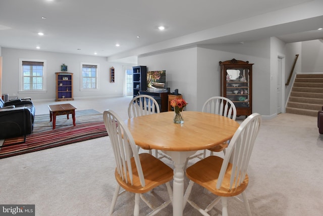 dining room featuring baseboards, stairway, recessed lighting, and light colored carpet