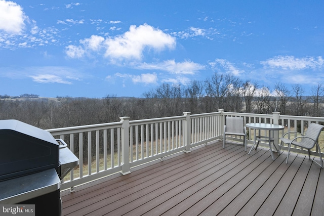 wooden deck with a grill