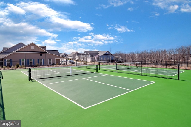 view of sport court featuring a residential view and fence