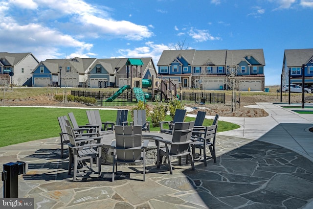 exterior space with a lawn, a patio, a residential view, fence, and playground community