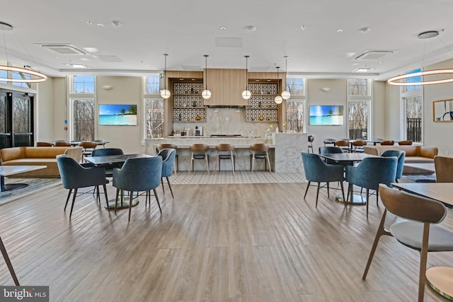 interior space featuring light wood finished floors and a community bar