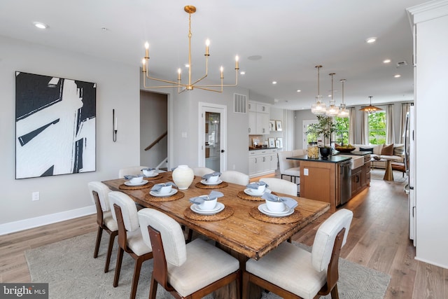 dining room featuring light hardwood / wood-style flooring and a notable chandelier