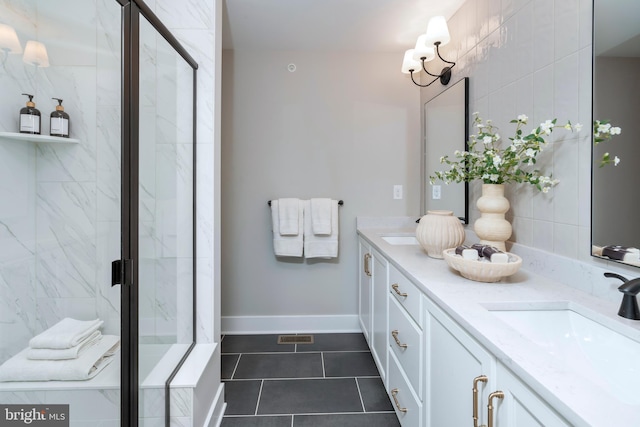 bathroom featuring vanity, a shower with shower door, and tile patterned flooring