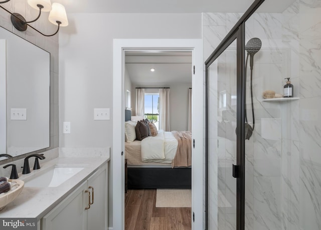 bathroom featuring an enclosed shower, vanity, and hardwood / wood-style flooring