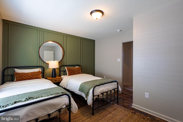 bedroom with dark hardwood / wood-style flooring