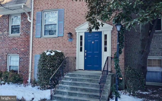 view of snow covered property entrance