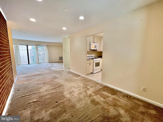 unfurnished living room with light colored carpet