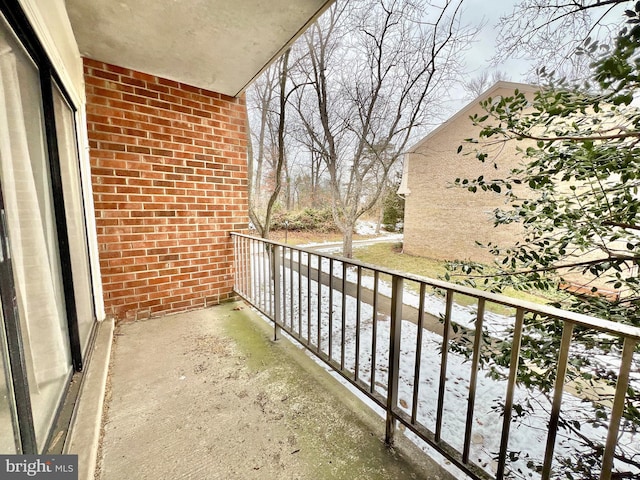 view of snow covered back of property