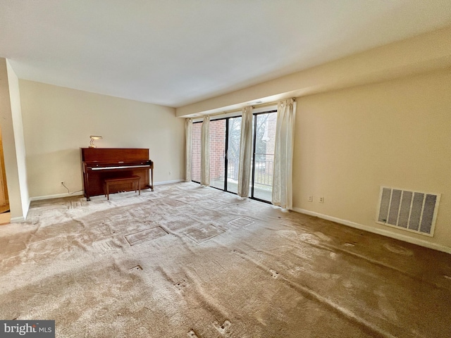 unfurnished living room featuring light colored carpet