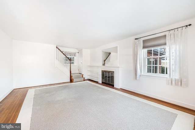 unfurnished living room featuring hardwood / wood-style flooring