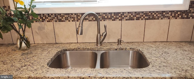 room details with light stone counters and sink