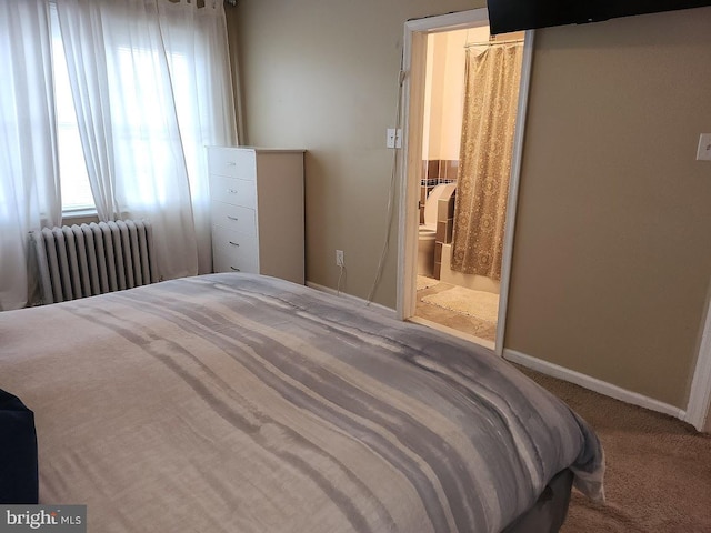 carpeted bedroom featuring connected bathroom and radiator