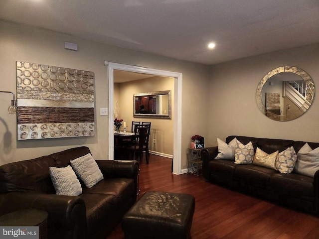 living room with dark hardwood / wood-style flooring