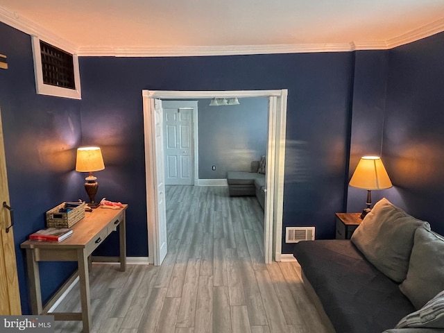 living room with hardwood / wood-style flooring and ornamental molding