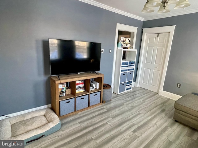 living room with light wood-type flooring and ornamental molding