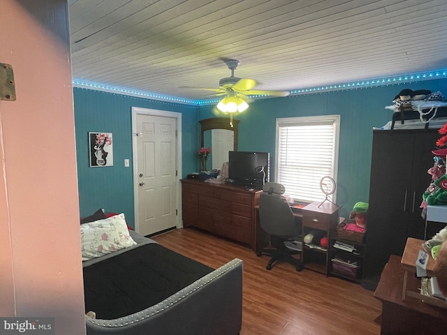 bedroom with ceiling fan, wood-type flooring, and wood ceiling