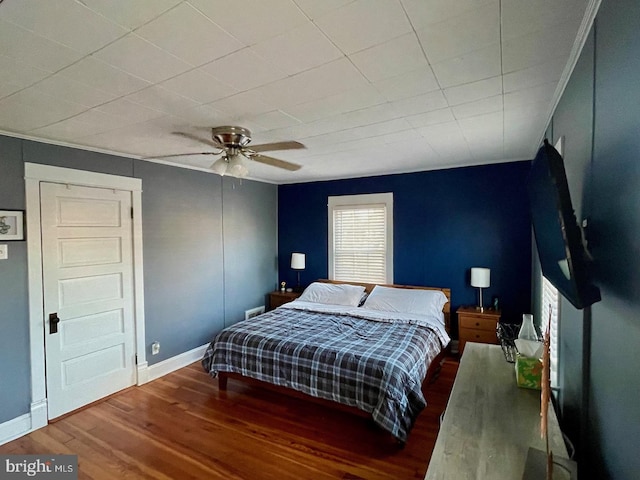 bedroom with ceiling fan and dark hardwood / wood-style floors