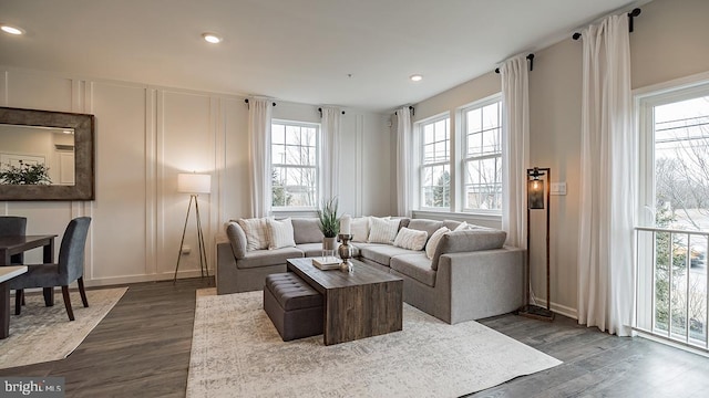 living room with plenty of natural light and dark hardwood / wood-style floors