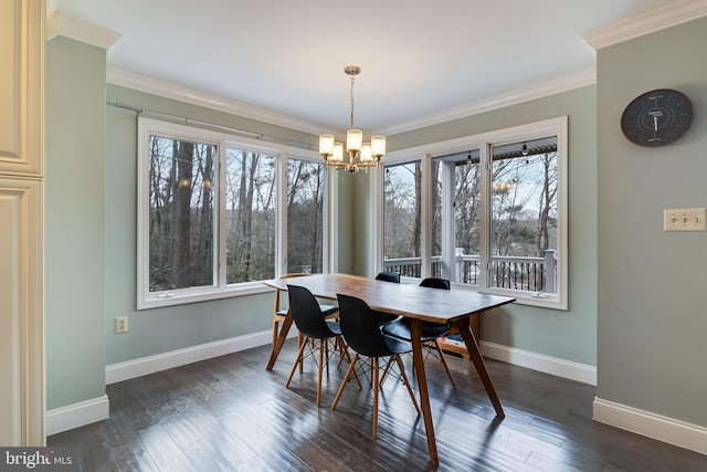 dining room featuring ornamental molding, dark hardwood / wood-style floors, and a chandelier