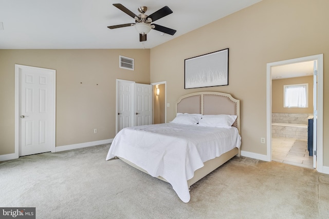 carpeted bedroom with vaulted ceiling, ensuite bathroom, and ceiling fan