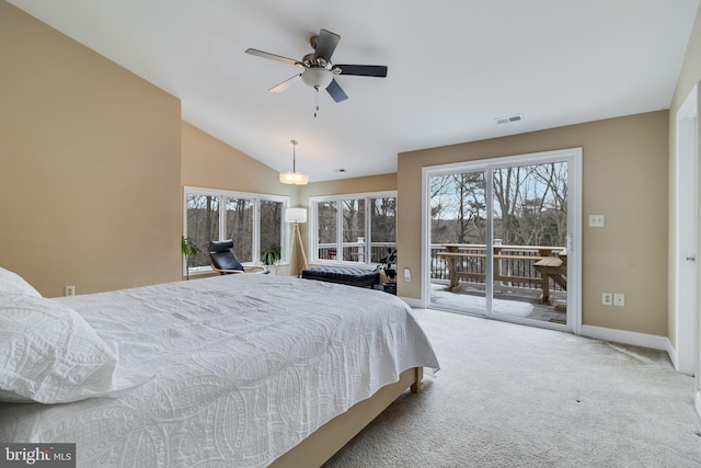 carpeted bedroom with vaulted ceiling and access to outside