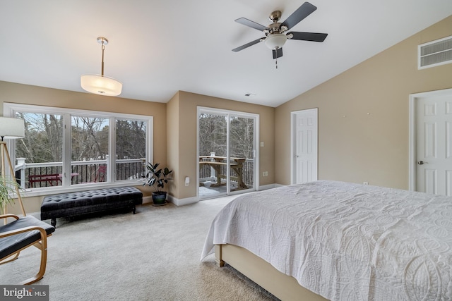 carpeted bedroom with vaulted ceiling and access to outside