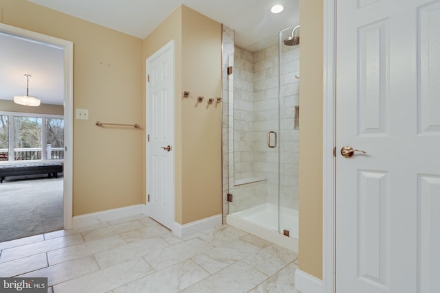 bathroom with a shower with door