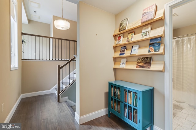 corridor with hardwood / wood-style flooring