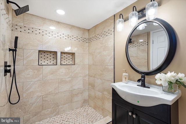 bathroom with vanity and tiled shower