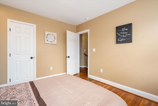 bedroom with hardwood / wood-style flooring